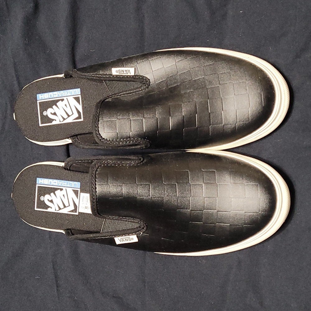 Black VANS mules.